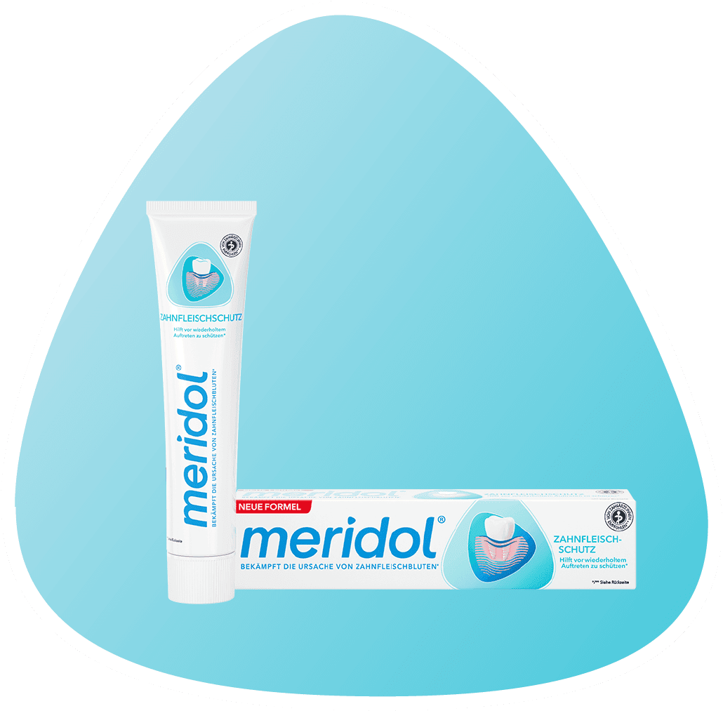 Zubná pasta meridol  v bielej tube s logom, vedľa balenia s grafikou znázorňujúcou ochranu ďasien.