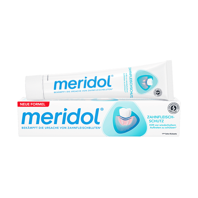 Obal a tuba zubnej pasty značky "meridol" na bielom pozadí. 